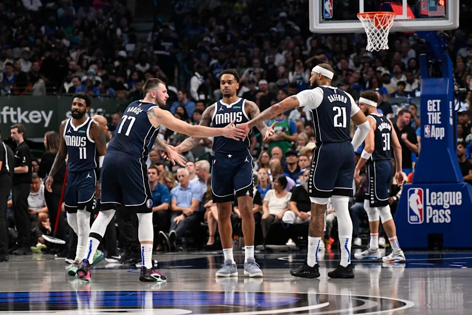 Dallas Mavericks guard Kyrie Irving (11), forward P.J. Washington (25), center Daniel Gafford (21), guard Klay Thompson (31), with former guard <em>Luka Doncic (77).</em>© Jerome Miron-Imagn Images