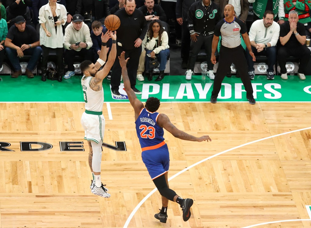  Jayson Tatum #0 of the Boston Celtics misses a three-point shot as Mitchell Robinson #23 of the New York Knicks defends during the fourth quarter.