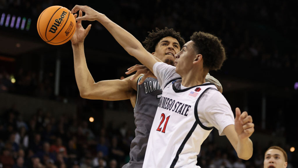 Miles Byrd #21 of the San Diego State Aztecs fouls Yaxel Lendeborg #3 of the UAB Blazers during the...