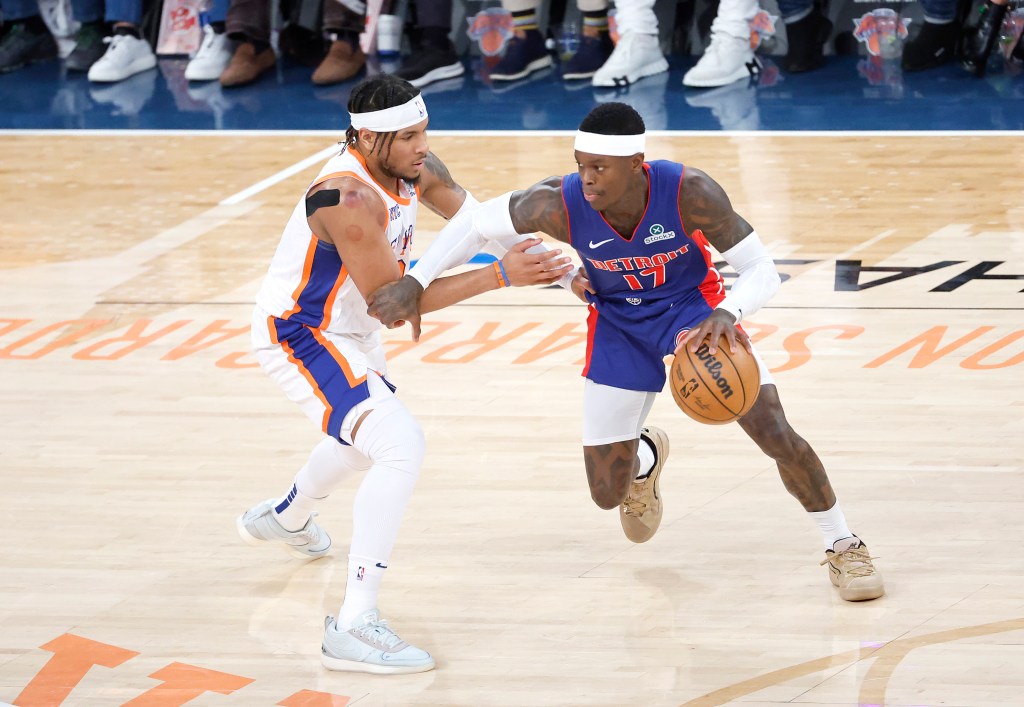 New York Knicks guard Miles McBride defends against Detroit Pistons guard Dennis Schroder.