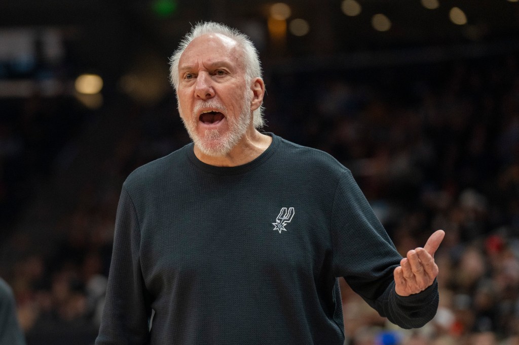 San Antonio Spurs head coach Gregg Popovich reacting with mouth open to an official's call during a basketball game in Salt Lake City, 2024.