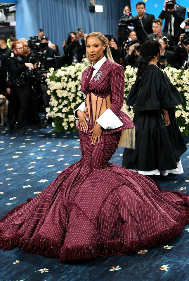Savannah James at the Met Gala in a pinstripe burgundy gown.
