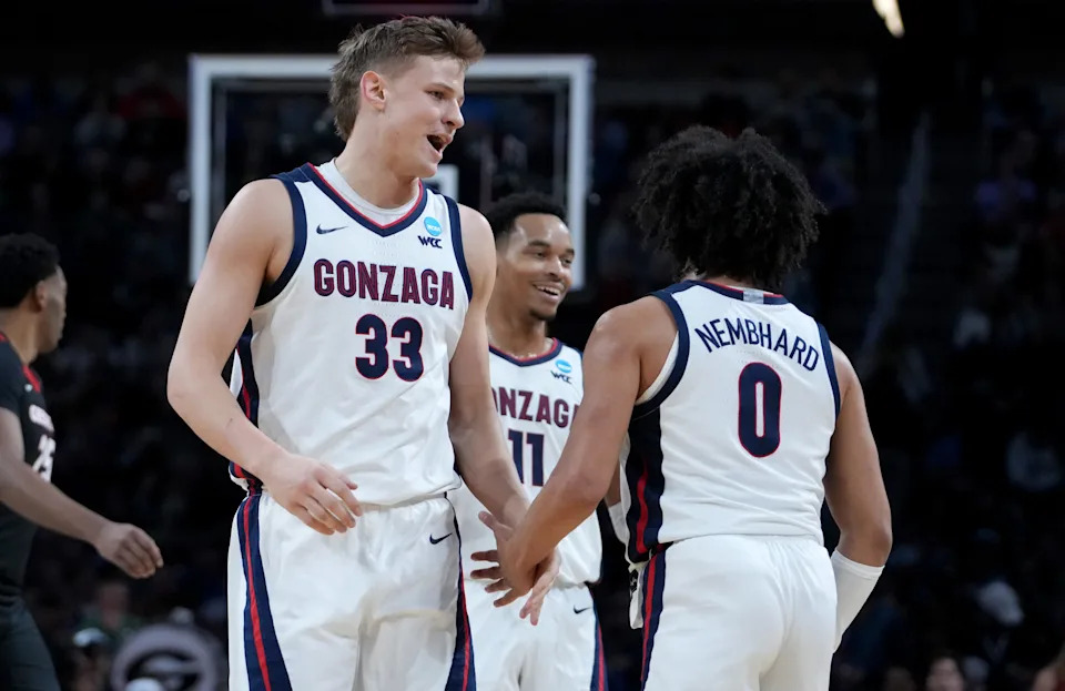 Mar 20, 2025; Wichita, KS, USA; Gonzaga Bulldogs forward Ben Gregg (33) celebrates with guard Ryan Nembhard (0) and guard Nolan Hickman (11) after a play in the first half of a first round men’s NCAA Tournament game against the Georgia Bulldogs at Intrust Bank Arena. Mandatory Credit: Kirby Lee-Imagn Images