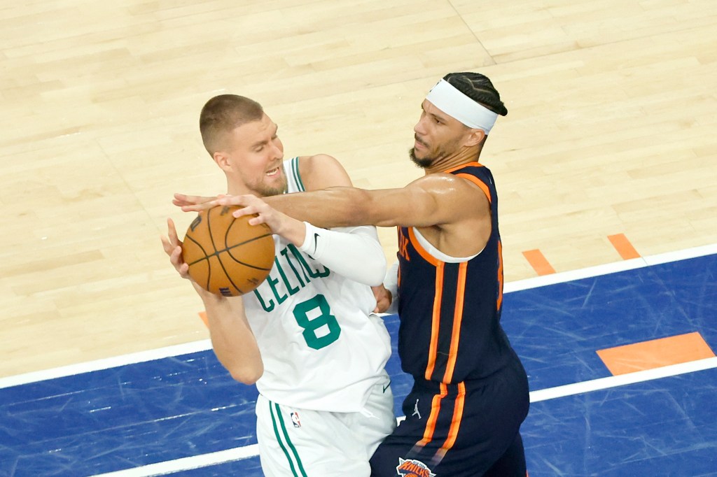 Josh Hart #3 of the New York Knicks defends against Kristaps Porzingis #8 of the Boston Celtics during the first quarter. 