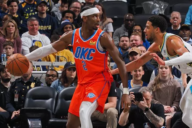 Tyrese Haliburton #0 of the Indiana Pacers plays defense on Shai Gilgeous-Alexander #2 of the Oklahoma City Thunder on December 26, 2024 at Gainbridge Fieldhouse in Indianapolis, Indiana