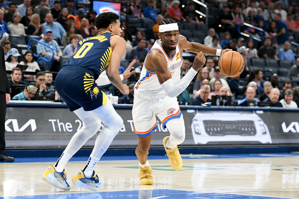 Oklahoma City Thunder guard Shai Gilgeous-Alexander, right, drives past Indiana Pacers guard Tyrese Haliburton, left, during the first half of an NBA basketball game, Saturday, March 29, 2025, in Oklahoma City. (AP Photo/Kyle Phillips)