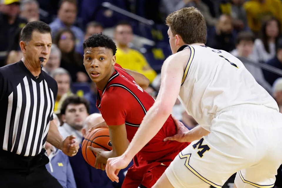Feb 27, 2025; Ann Arbor, Michigan, USA; Rutgers Scarlet Knights guard Ace Bailey (4) is defended by Michigan Wolverines center Danny Wolf (1) in the second half at Crisler Center. Mandatory Credit: Rick Osentoski-Imagn Images