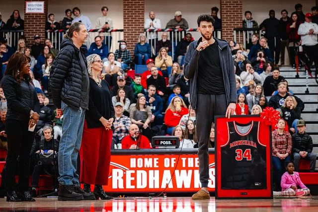 Zach Beeker/NBAE via Getty Chet Holmgren celebrates the retirement of his high-school jersey on January 19, 2024 at Minnehaha Academy in Minneapolis, Minnesota.