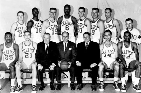 BOSTON - 1962: The World Champions of basketball Boston Celtics pose for a team portrait seated (L-R): K. C. Jones Gary Phillips, President Walter A. Brown, Head Coach Red Auerbach, Treasurer Lou Pieri, Captain Bob cousy, Sam Jones. Standing Frank Ramsey, Tom Sanders, tom Heinsohn, Bill russell Gene Guarillia, Jim Loscutoff, Carl Brown, Trainer Buddy LeRoux in Boston, Massachusetts in 1962. NOTE TO USER: User expressly acknowledges and agrees that, by downloading and or using this photograph, User is consenting to the terms and conditions of the Getty Images License Agreement. Mandatory copyright notice: Copyright NBAE 2002 (Photo by NBAP/ NBAE/ Getty Images)