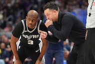 San Antonio Spurs interim head coach Mitch Johnson, right, confers with guard Chris Paul (3)...