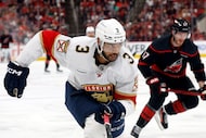 Florida Panthers' Seth Jones (3) chases the puck in front of Carolina Hurricanes' Andrei...