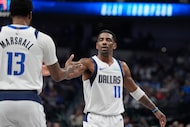 Dallas Mavericks guard Kyrie Irving (11) congratulates teammate forward Naji Marshall (13)...