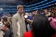 Dallas Mavericks' Cooper Flagg, the No. 1 overall pick in the NBA draft, talks to a reporter...