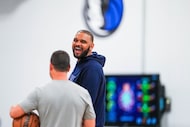 Dallas Mavericks coach Jared Dudley laughs with other coaches during a practice in...
