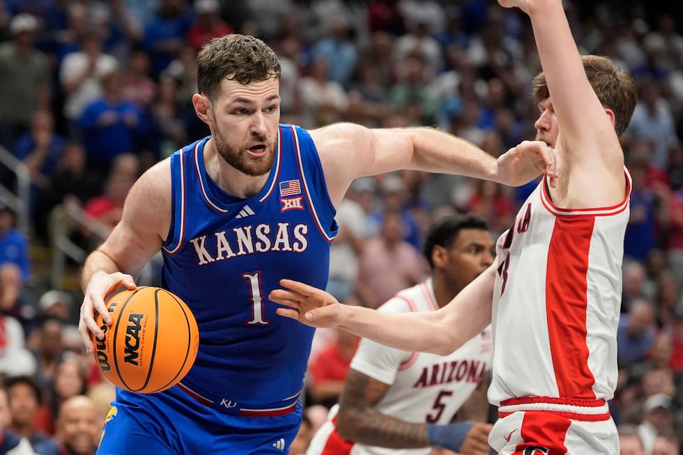 Kansas' Hunter Dickinson (1) drives past Arizona's Henri Veesaar during the first half of an...