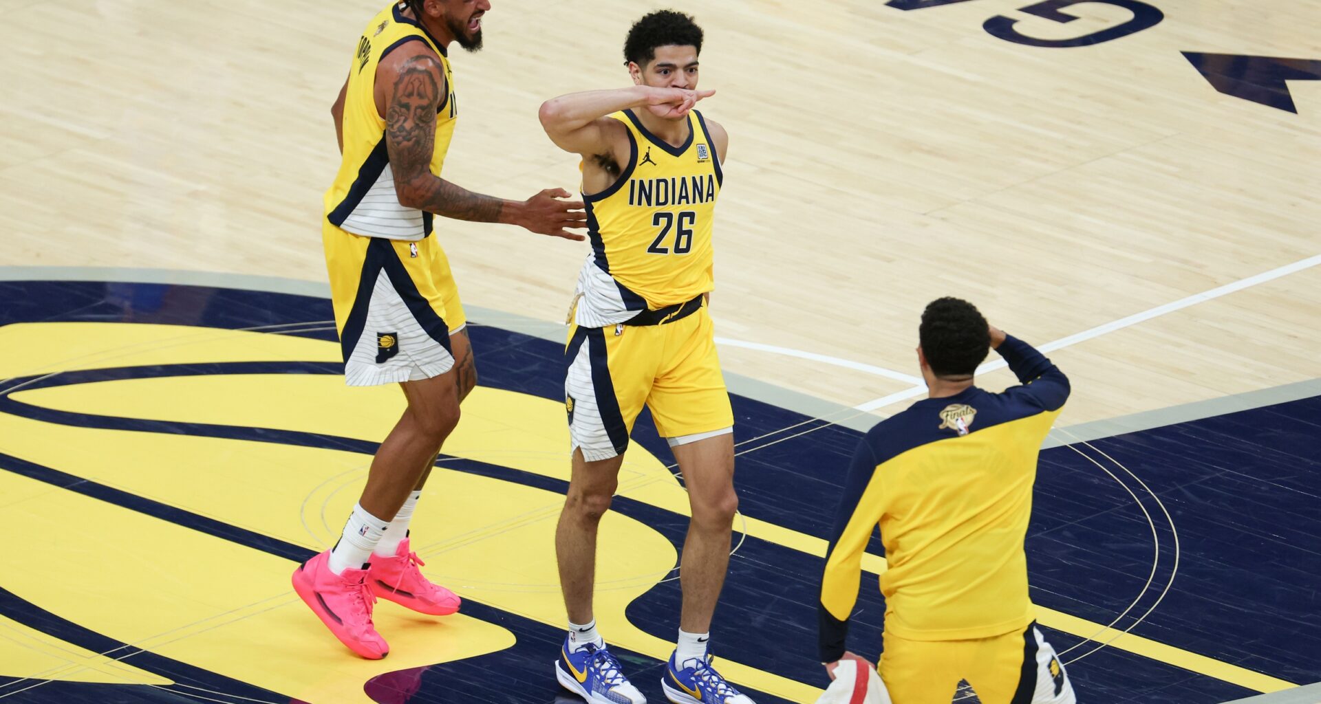 Indiana Pacers guard Ben Sheppard (26) celebrates with teammates after hitting a shot against the Oklahoma City Thunder as time expires in the third quarter during game six of the 2025 NBA Finals at Gainbridge Fieldhouse.