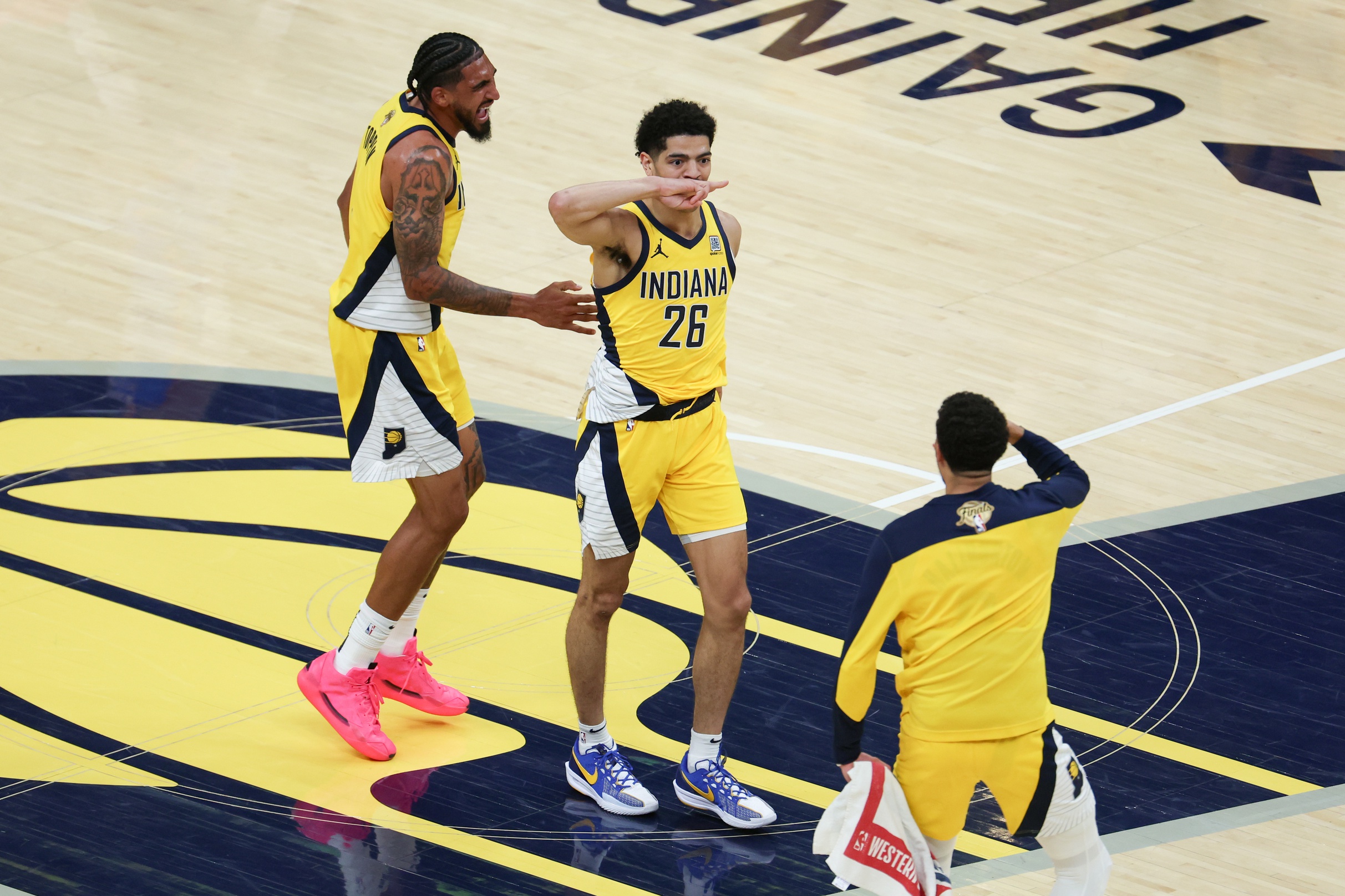 Indiana Pacers guard Ben Sheppard (26) celebrates with teammates after hitting a shot against the Oklahoma City Thunder as time expires in the third quarter during game six of the 2025 NBA Finals at Gainbridge Fieldhouse.