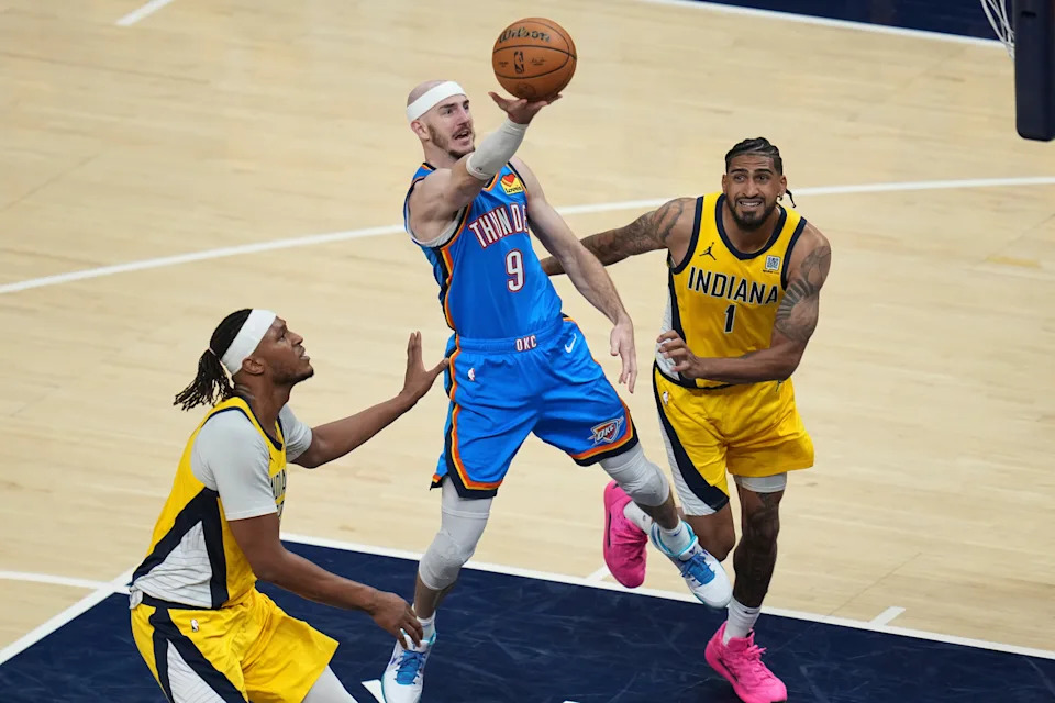 Oklahoma City Thunder guard Alex Caruso (9) shoots past Indiana Pacers forward Obi Toppin (1) during the second half of Game 4 of the NBA Finals basketball series, Friday, June 13, 2025, in Indianapolis. (AP Photo/Michael Conroy)