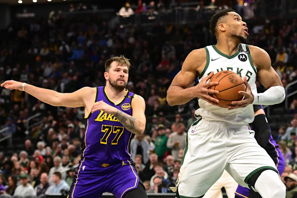 Milwaukee Bucks forward Giannis Antetokounmpo (34) controls the ball against Los Angeles Lakers guard Luka Doncic (77) in the first quarter at Fiserv Forum.Benny Sieu-Imagn Images