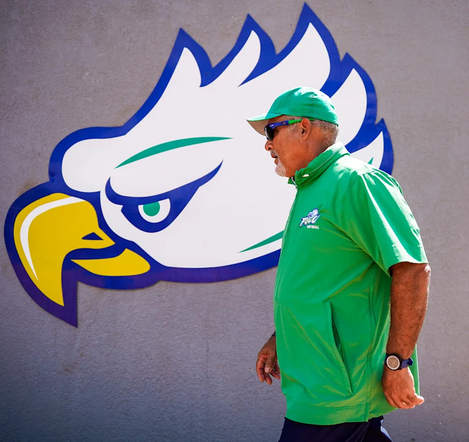 Florida Gulf Coast Eagles head coach David Deiros walks past the school logo before an ASUN Conference game at Florida Gulf Coast's softball complex in Fort Myers, Fla., on Friday, May 2, 2025.