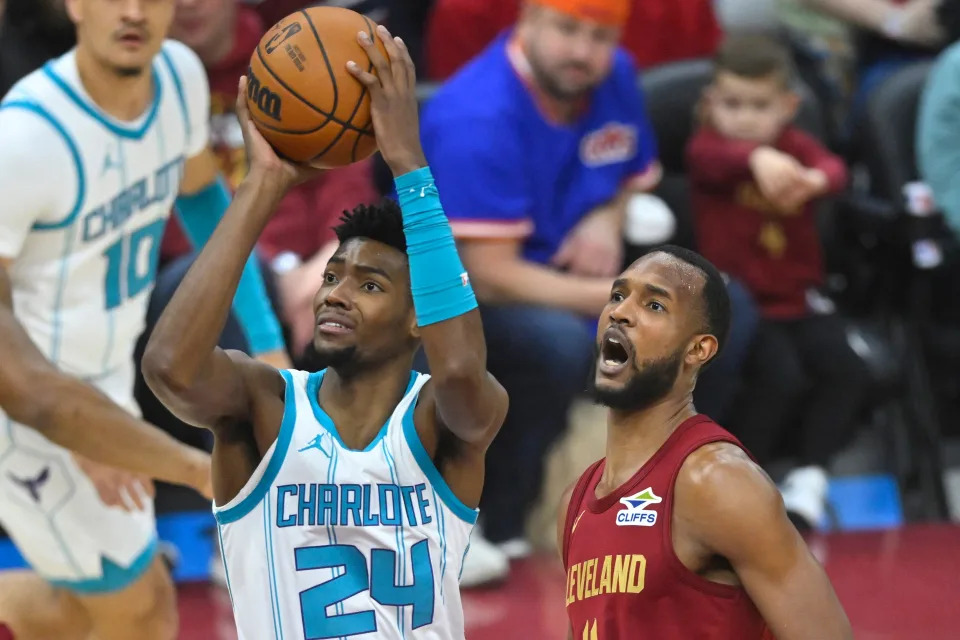 Hornets forward Brandon Miller shoots beside Cavaliers forward Evan Mobley in the first quarter, Jan. 5, 2025, in Cleveland.