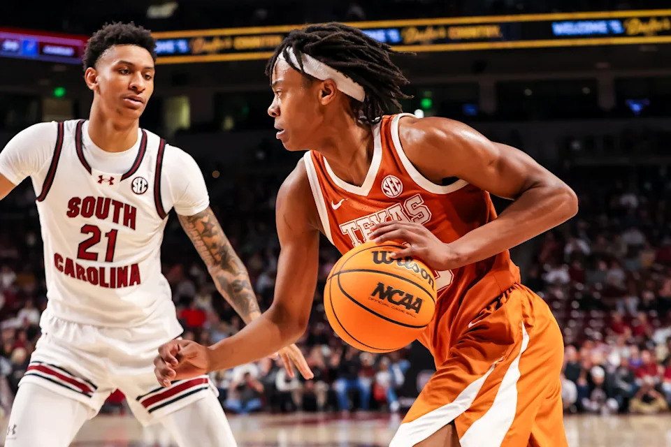 Feb 22, 2025; Columbia, South Carolina, USA; Texas Longhorns guard Tre Johnson (20) drives past South Carolina Gamecocks guard Arden Conyers (21) in the second half at Colonial Life Arena. Mandatory Credit: Jeff Blake-Imagn Images