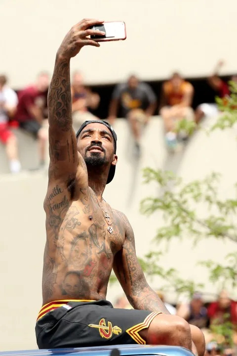J.R. Smith #5 of the Cleveland Cavaliers takes a photo as the crowd cheers during the Cleveland Cavaliers 2016 NBA Championship victory parade and rally on June 22, 2016 in Cleveland, Ohio. (Photo by Mike Lawrie/Getty Images)