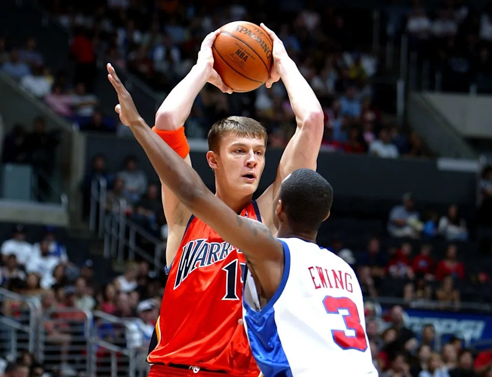 LOS ANGELES, CA - NOVEMBER 20: Andris Biedrins #15 of the Golden State Warriors looks for an open pass over Daniel Ewing #3 of the Los Angeles Clippers during the game on November 20, 2005 at Staples Center in Los Angeles, California. The Clippers won 113-101. NOTE TO USER: User expressly acknowledges and agrees that, by downloading and/or using this Photograph, user is consenting to the terms and conditions of the Getty Images License Agreement (Photo by Jeff Gross/Getty Images)