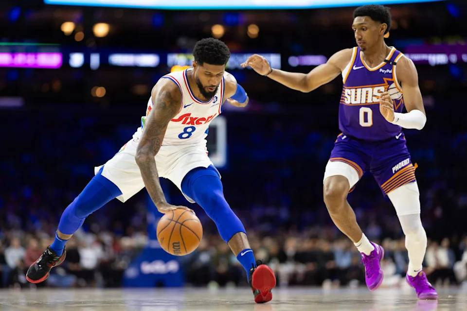 Philadelphia 76ers forward Paul George controls the ball against Phoenix Suns forward Ryan Dunn.Bill Streicher-Imagn Images