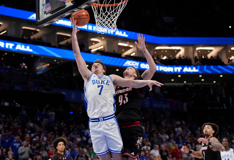 Duke Blue Devils guard Kon Knueppel (7) drives against Louisville Cardinals forward Noah Waterman.Jim Dedmon-Imagn Images