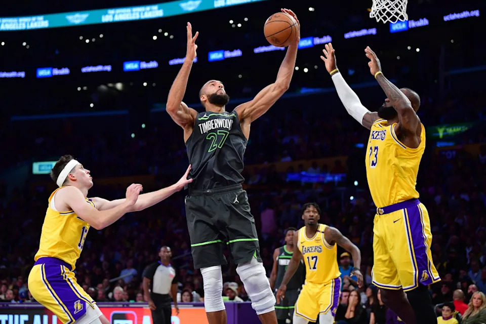 Minnesota Timberwolves center Rudy Gobert (27) against Los Angeles Lakers guard Austin Reaves (15) and forward LeBron James (23).Gary A. Vasquez-Imagn Images