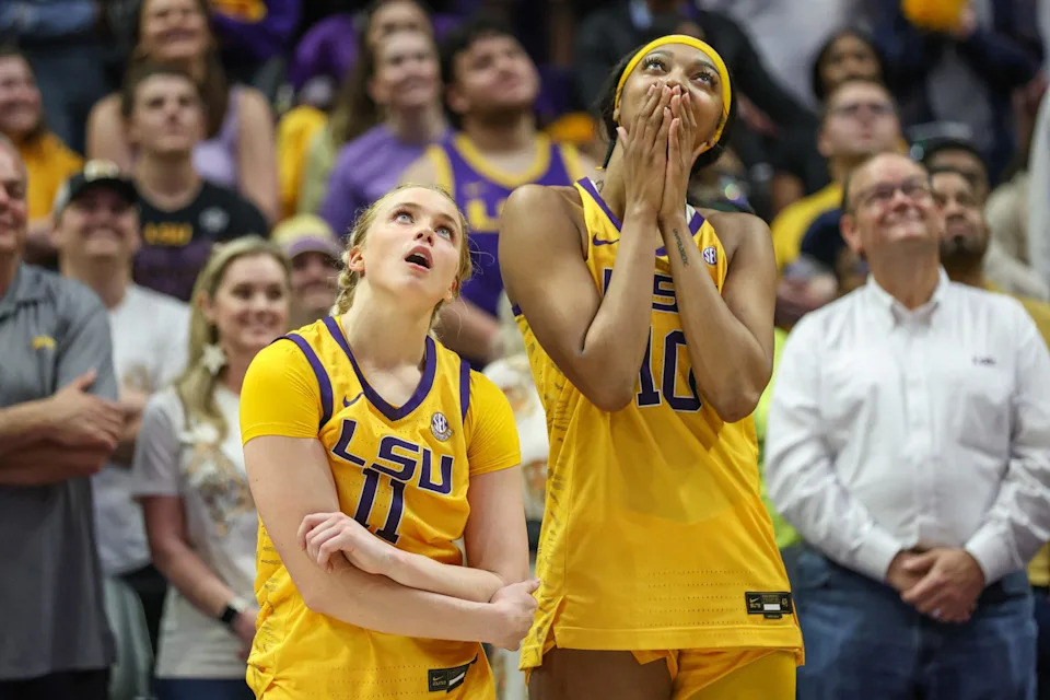 LSU seniors Hailey Van Lith (11) and Angel Reese (10) look up at the video board for a senior tribute video after NCAA Women's Basketball game action between the Kentucky Wildcats and the LSU Tigers at the Pete Maravich Assembly Center in Baton Rouge, LA.