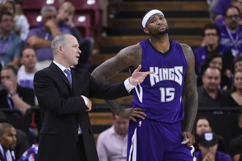 October 29, 2014; Sacramento, CA, USA; Sacramento Kings head coach Michael Malone (left) instructs center DeMarcus Cousins (15) during the fourth quarter against the Golden State Warriors at Sleep Train Arena. The Warriors defeated the Kings 95-77. © Kyle Terada-Imagn Images