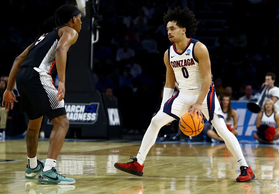 Mar 20, 2025; Wichita, KS, USA; Gonzaga Bulldogs guard Ryan Nembhard (0) dribbles against Georgia Bulldogs guard Silas Demary Jr. (5) in the first half of a first round men’s NCAA Tournament game at Intrust Bank Arena. Mandatory Credit: Nick Tre. Smith-Imagn Images Nick Tre&period; Smith-Imagn Images