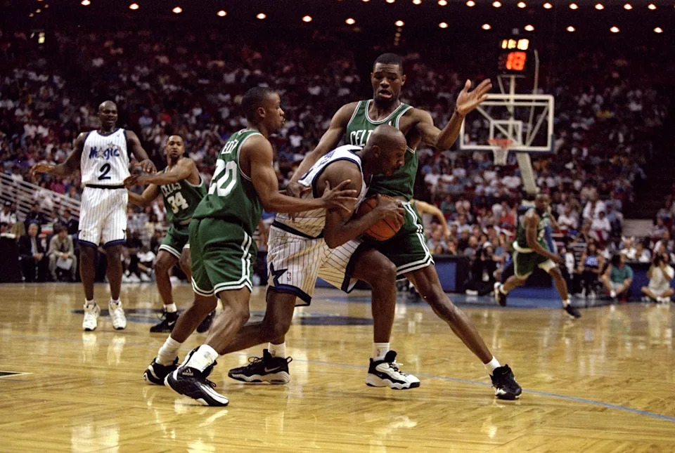 ORLANDO - APRIL 1: Guard Tyus Edney and forward Walter McCarty of the Boston Celtics surround guard Derek Harper of the Orlando Magic during a game at the Orlando Arena on April 1, 1998 in Orlando, Florida. The Celtics defeated the Magic 98-87. NOTE TO USER: User expressly acknowledges and agrees that, by downloading and/or using this Photograph, User is consenting to the terms and conditions of the Getty Images License Agreement. (Photo by Andy Lyons/Getty Images)