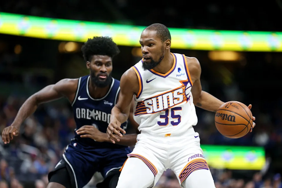 Phoenix Suns forward Kevin Durant drives to the hoop past Orlando Magic forward Jonathan Isaac.Nathan Ray Seebeck-Imagn Images