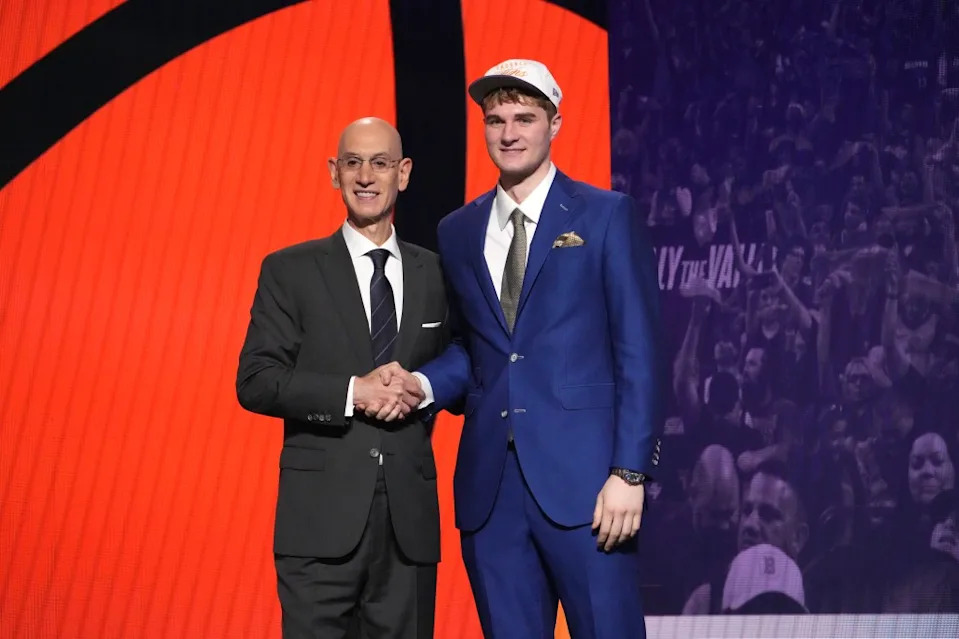 Liam McNeeley with NBA commissioner Adam Silver during the 2025 NBA Draft festivities. NBAE via Getty Images