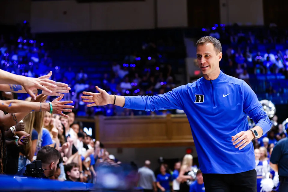 Duke Blue Devils head coach Jon Scheyer reaches for the fans during Countdown to Craziness at Cameron Indoor Stadium.Jaylynn Nash-Imagn Images