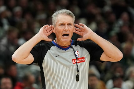 FILE - Referee Scott Foster (48) gestures during the second half of an NBA basketball game...