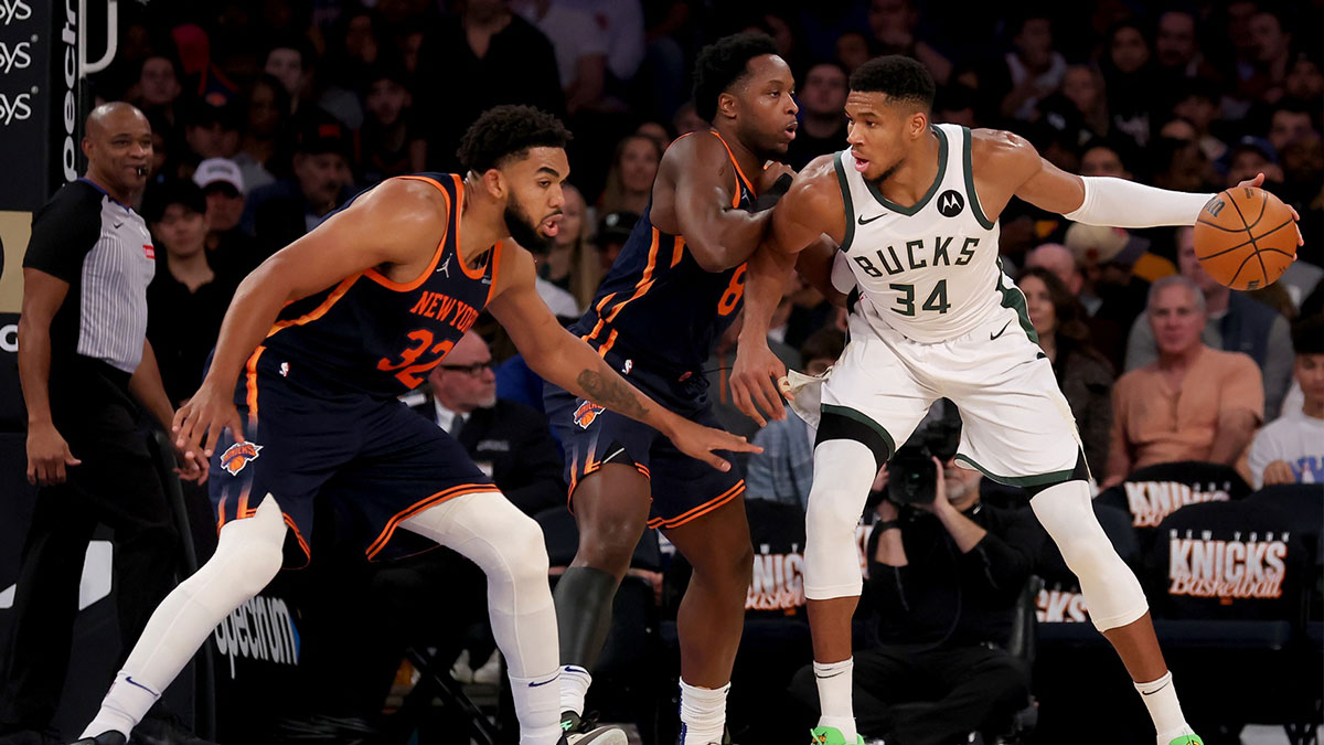 Milwaukee Bucks forward Giannis Antetokounmpo (34) controls the ball against New York Knicks forward OG Anunoby (8) and center Karl-Anthony Towns (32) during the third quarter at Madison Square Garden. 