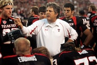FILE - Texas Tech head coach Mike Leach talks with his team in the second quarter of an NCAA...