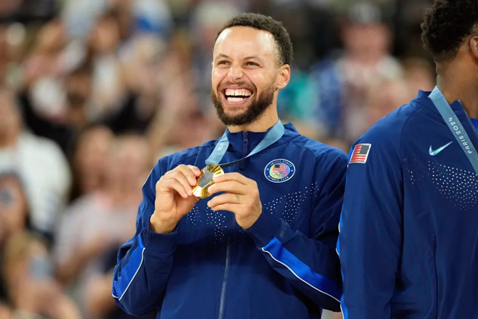 Team USA's Stephen Curry celebrates with the gold medal at the 2024 Paris Olympics.Kyle Terada-USA TODAY Sports