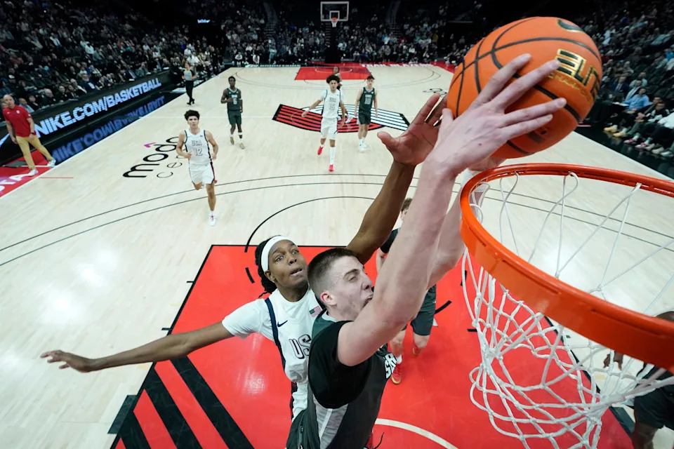 PORTLAND, OREGON - APRIL 12: Bogoljub Markovic #6 of Team World dunks against Jasper Johnson (L) #8 of Team USA during the 2025 Nike Hoop Summit at Moda Center on April 12, 2025 in Portland, Oregon. (Photo by Soobum Im/Getty Images)