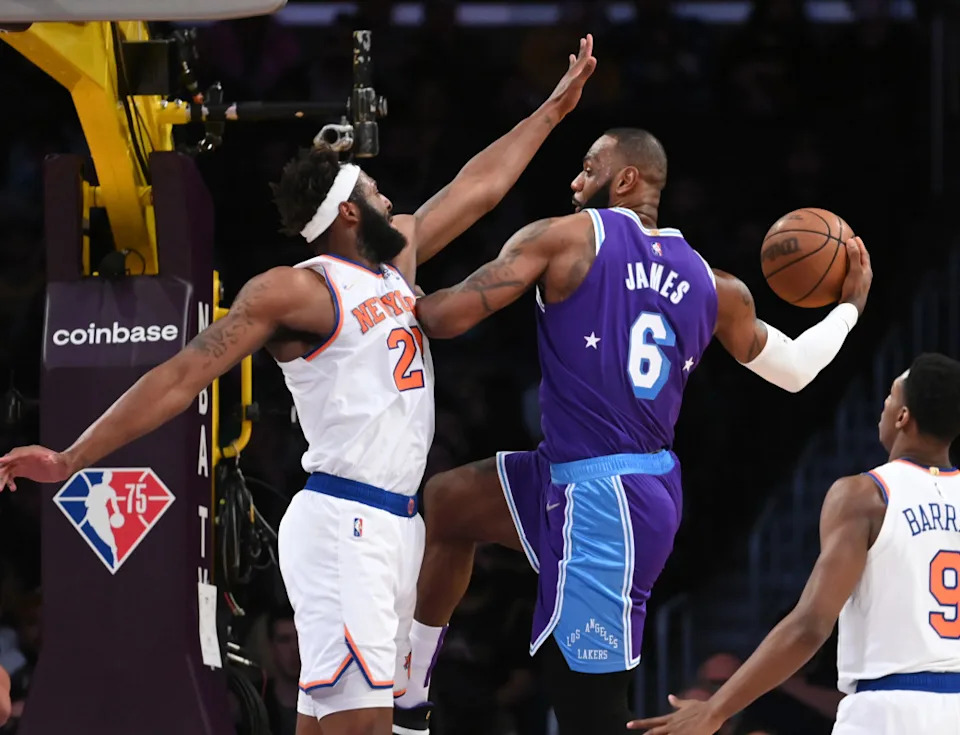  New York Knicks center Mitchell Robinson (23) defends a pass by Los Angeles Lakers forward LeBron James (6) in the first quarter of the game at Crypto.com Arena. Mandatory Credit&colon; Jayne Kamin-Oncea-Imagn Images