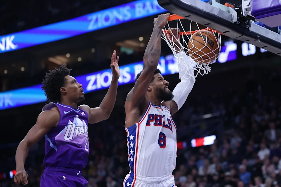 Dec 28, 2024; Salt Lake City, Utah, USA; Philadelphia 76ers forward Paul George (8) dunks the ball past Utah Jazz guard Collin Sexton (2) during the second quarter at Delta Center. Mandatory Credit: Rob Gray-Imagn Images