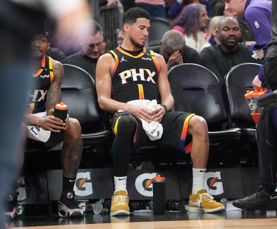 Phoenix Suns guard Devin Booker (1) sits on the bench during a timeout against the Oklahoma City Thunder in the fourth quarter at PHX Arena in Phoenix, on April 9, 2025.