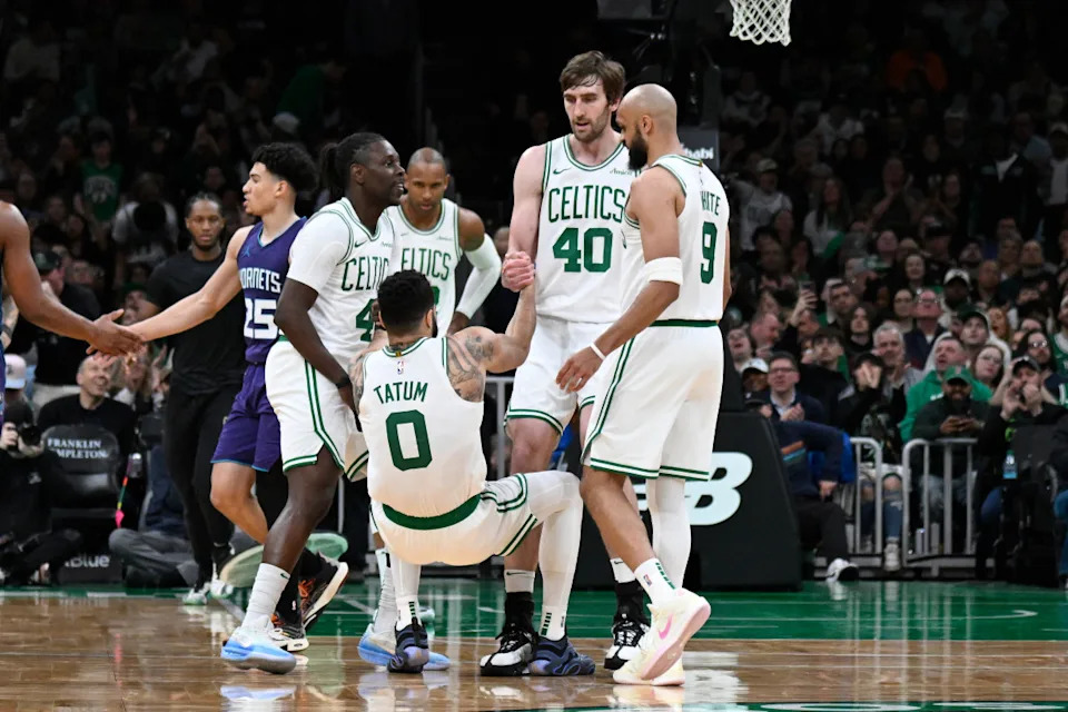 Boston Celtics forward Jayson Tatum, guards Jrue Holiday and Derrick White and center Luke KornetEric Canha-Imagn Images