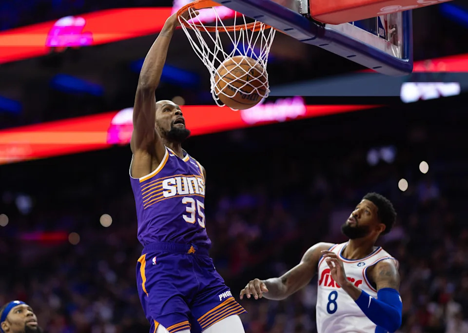Phoenix Suns forward Kevin Durant dunks against Philadelphia 76ers forward Paul George.Bill Streicher-Imagn Images