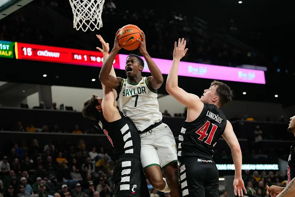 Jan 7, 2025; Waco, Texas, USA; Baylor Bears guard VJ Edgecombe (7) scores a layup between Cincinnati Bearcats guard Connor Hickman (8) and guard Simas Lukosius (41) during the first half at Paul and Alejandra Foster Pavilion. Mandatory Credit: Chris Jones-Imagn Images