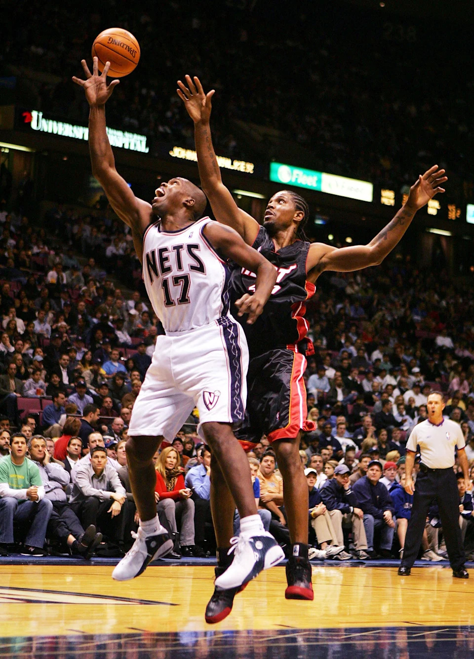 EAST RUTHERFORD, NJ - NOVEMBER 3: Eric Williams #17 of the New Jersey Nets and Udonis Haslem #40 of the Miami Heat go for a rebound on November 3, 2004 at Continental Airlines Arena in East Rutherford, New Jersey. NOTE TO USER: User expressly acknowledges and agrees that, by downloading and/or using this photograph, User is consenting to the terms and conditions of Getty Images License Agreement. (Photo by Ezra Shaw/Getty Images)